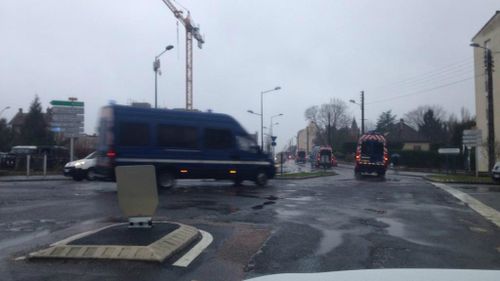 A police convoy leaves Villers-Cotterets with lights and sirens blaring toward the reported shooting near Charles de Gaulle airport. (Andrew Lund)