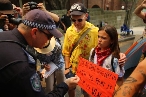 Protesters react after police threaten to arrest them during a protest outside of Kirribilli House in Sydney, Thursday, December 19, 2019. 