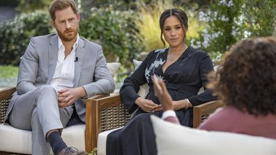 This image provided by Harpo Productions shows Prince Harry, from left, and Meghan, The Duchess of Sussex, in conversation with Oprah Winfrey. (Joe Pugliese/Harpo Productions via AP)