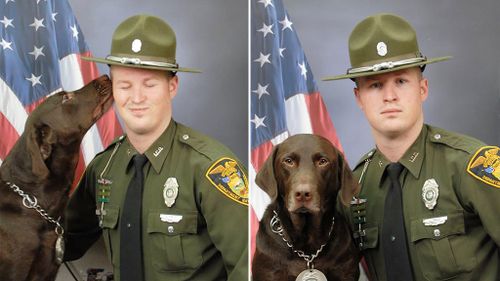 K9 police dog 'kisses' his partner while posing for official photo