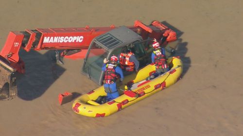 Stranded in the middle of a flooded paddock at the Sydney suburb of Orchard Hills, farmer Marcos Leon clings to the cab of his submerged machinery.. The 75-year-old had been trying to reach his horses when he became stuck and his daughter raised the alarm.