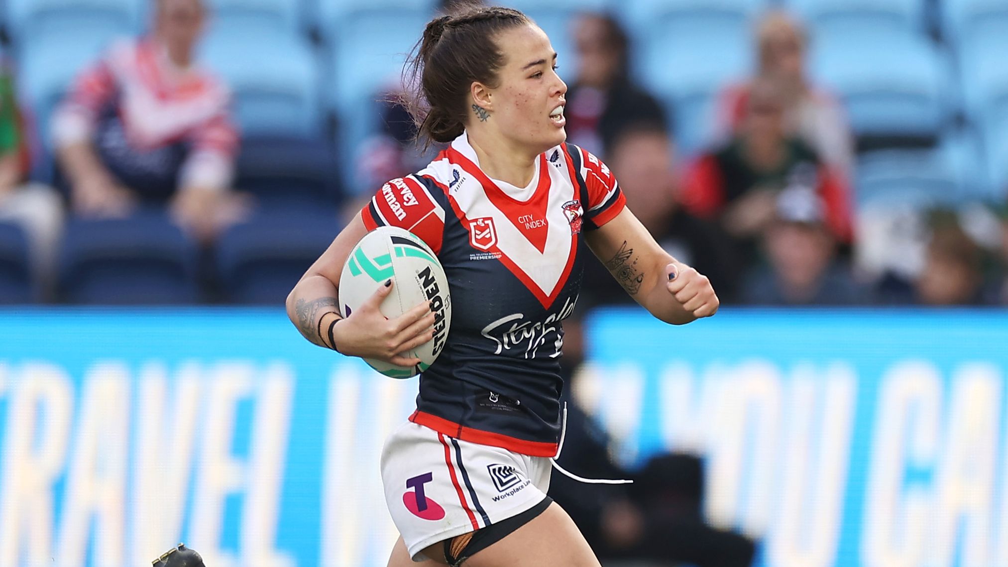 Isabelle Kelly of the Roosters breaks away to score a try against the Knights.