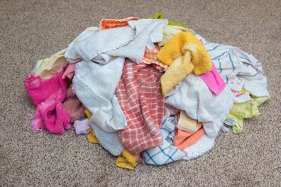 A Load of Clean Hand Towels Ready to Be Folded on the Floor