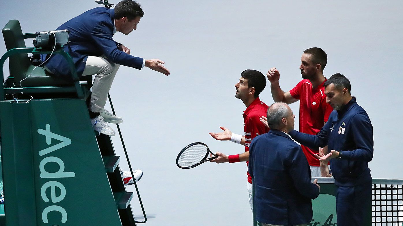 Novak Djokovic of Serbia, team mate Viktor Troicki, Coach Nenad Simic and Tournament Referee Wayne McKewen talk to the umpire during their quarter final doubles match
