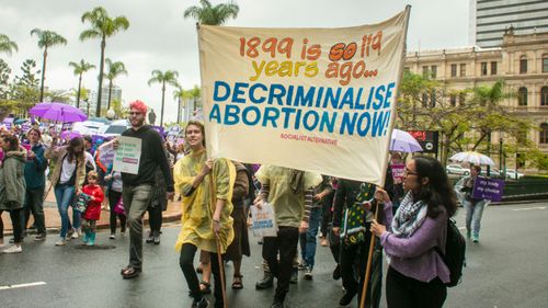 People are seen attending the March together for Choice rally in Brisbane last weekend.