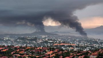 Smoke rises during protests in Noumea, New Caledonia, Wednesday May 15, 2024. 