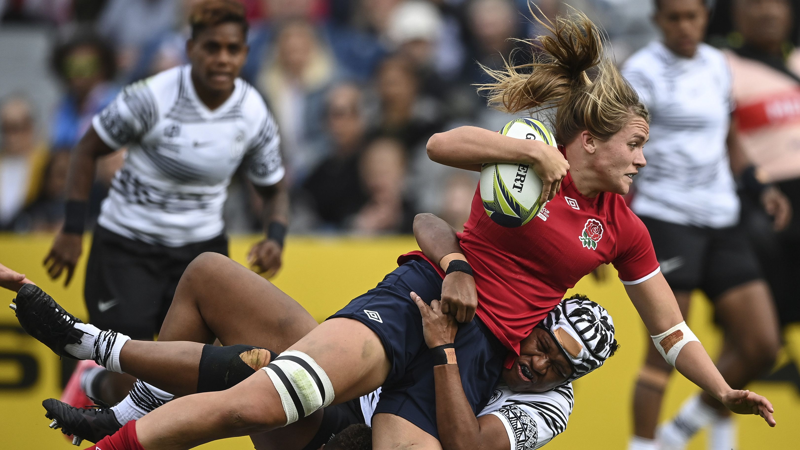 Zoe Aldcroft of England is tackled by a defender.