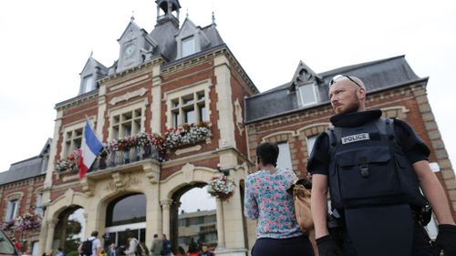 Police stand guard outside the Saint-Etienne-du-Rouvray's city hall. (AFP)