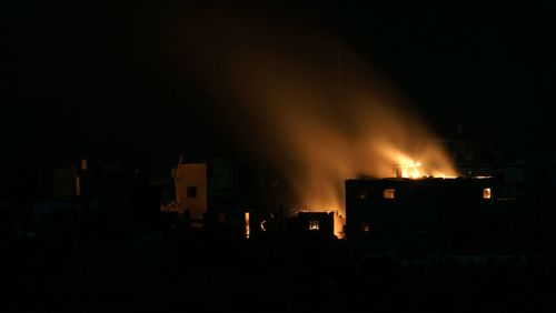 Flames engulf a building following an Israeli airstrike in the Gaza Strip
