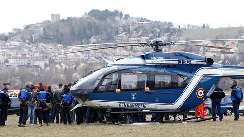Members of the French Gendarmerie gather close to a helicopter in Seyne les Alpes near the crash site. (AAP)