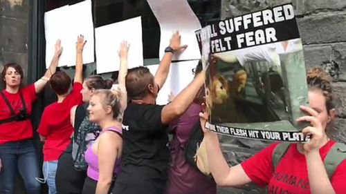 The activists were kicked out of the restaurant but continued their protest outside. (Facebook)