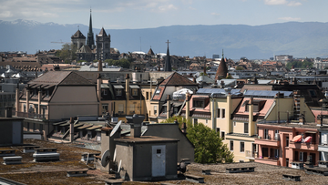 This picture taken on May 13, 2019 shows the St. Pierre Cathedral overlooking the roofs in the center of Geneva. (Photo by Fabrice COFFRINI / AFP)      