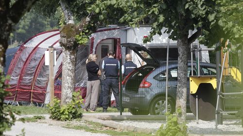 Investigators stand at the camp site where a slain British family were holidaying in Saint Jorioz, near Annecy, on September 6, 2012.