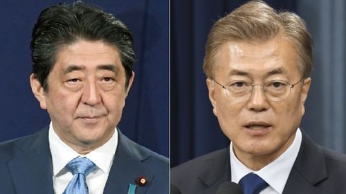 Japanese Prime Minister Shinzo Abe (left), and South Korean President Moon Jae-in (right). (AAP)