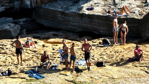 Groups of young people flout the social distancing guidelines at Bondi Beach, in Sydney.