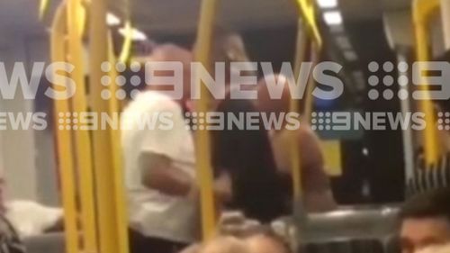 The man can be seen trying to punch and headbutt the teenagers. (9NEWS)
