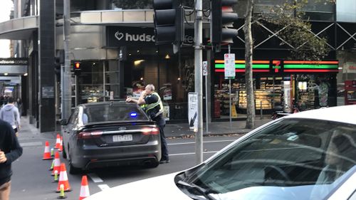 Police are currently doing safety checks on the bus at the intersection of King and Londsdale Streets. Picture: 9NEWS/Sean Davidson.