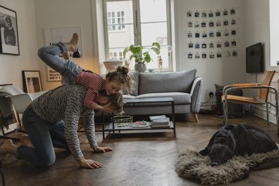 Dad playing with children on the lounge room floor