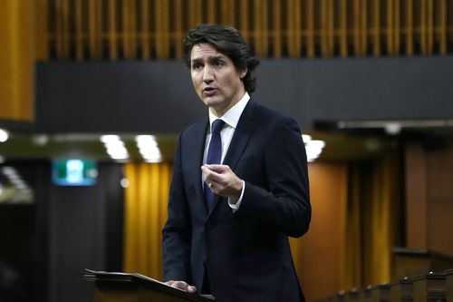 Prime Minister Justin Trudeau rises during an emergency debate in the House of Commons on the situation in Ottawa, as a protest against COVID-19 restrictions that has been marked by gridlock and the sound of truck horns continues into its second week, in Ottawa, Monday, February 7, 2022. 