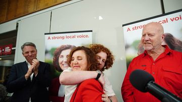 Successful candidate for Dunkley Jodie Belyea celebrates with a hug from her son Flynn Glazebrook at the Frankston Bowling Club after winning the Dunkley by-election on Saturday 2 March 2024.