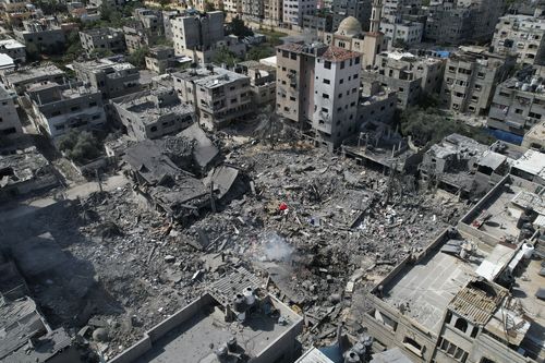 Buildings destroyed in Israeli airstrikes on Bureij refugee camp, Gaza Strip, are seen Wednesday, Oct. 18, 2023 