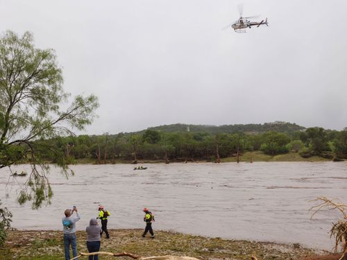A Texas DPS helicopter conducts arial searches along the Guadalupe River in Kerrville on July 4.