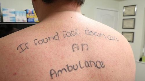 British man laughs off mate tattooing his back while passed out drunk