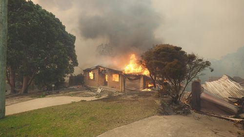 Around 700 people fled Tathra on Sunday night as the fire tore through properties and homes, seeking shelter in evacuation centres in Bega and Bermagui. Picture: AAP.