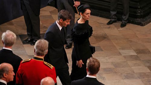 Royal funeral guests wear quiet tributes to the Queen