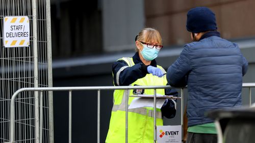 A security guard takes a delivery outside the Rydges Hotel which is being used as a quarantine hotel on July 10, 2020 in Auckland, New Zealand