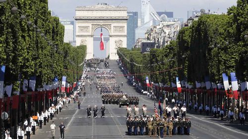 Troops march down the Champs Elysees during Paris' Bastille Day parade. (AAP)