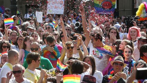 The crowd react to the same-sex marriage postal survey Yes result in front of the State library of Victoria in Melbourne.