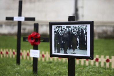 A picture of the late Queen Elizabeth II is displayed as Camilla, the Queen Consort attend the 94th Field of Remembrance service at Westminster Abbey in London, Thursday, Nov. 10, 2022 