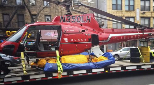 The Liberty Helicopters aircraft that crashed into the East River has been salvaged for further investigation. (AAP)