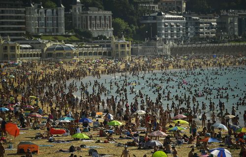 Thousands are flocking to Portugal's beaches to try and escape the heat. Image: AAP