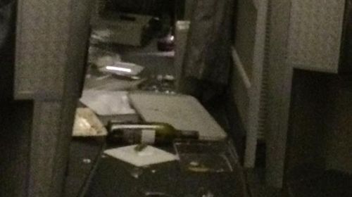 In another photo from Mr Stanley's Facebook page bottles of wine and broken glasses can be seen strewn across the aisle. (Supplied)