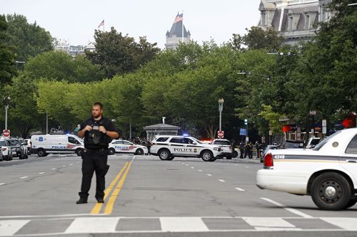 Law enforcement officials gather following a shooting that took place at 17th Street and Pennsylvania Avenue near the White House.