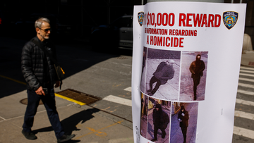 A pedestrian walks past a bulletin posted by NYPD near the place where a homeless person was killed days earlier in lower Manhattan, Monday, March 14, 2022, in New York.
