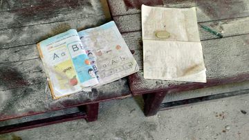 Two books lie in a school in Let Yet Kone village in Tabayin township in the Sagaing region of Myanmar after an attack