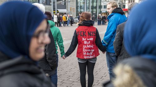 People gather on Market Square to commemorate the victims of the recent shooting on February 21, 2020 in Hanau, Germany. On the night of February 19 a local man named Tobias Rathjen shot dead nine people in Hanau before likely turning the gun on his mother and himself. Police suspect a right-wing motive to the crime