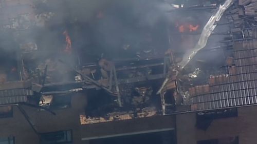 The fire spread to the roof of the unit block in Merrylands.