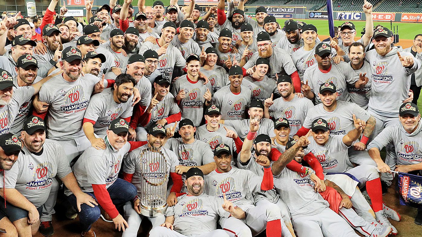 The Washington Nationals pose for a team photo as they celebrate after defeating the Houston Astros in Game Seven 