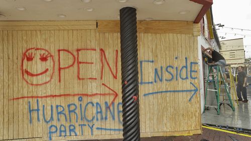 Owners board up a bar a few blocks off Daytona Beach. (AAP)
