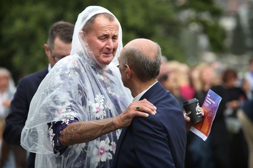 Mourners comfort one another on the 20th anniversary of the Bali bombings, which killed 202 people including 88 Australians.