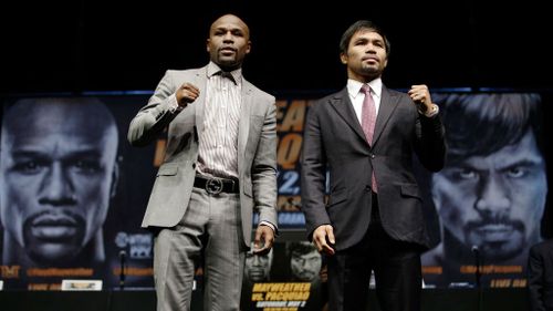 Boxers Floyd Maywetaher Jr. and Manny Pacquiao pose for photos after news conference. (AP)