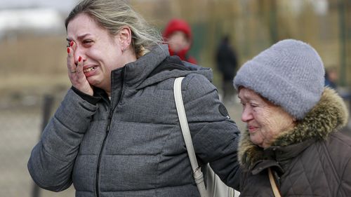 A Ukrainian woman cries after arriving at the Medyka border crossing, in Poland.