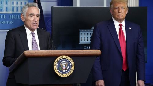 White House coronavirus adviser Dr Scott Atlas speaks as President Donald Trump listens during a news conference at the White House.