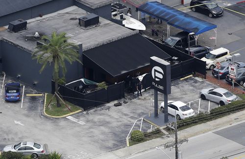 In this June 12, 2016 file photo, law enforcement officials work at the Pulse nightclub in Orlando, Fla., following a mass shooting. The widow of the gunman who killed dozens of people at the Pulse nightclub in Orlando is going on trial Wednesday, March 14, 2018, in federal court. Thirty-one-year-old Noor Salman is charged with aiding and abetting her deceased husband Omar Mateen in planning the 2016 attack on the Pulse nightclub. (AP Photo/Chris O'Meara, File)