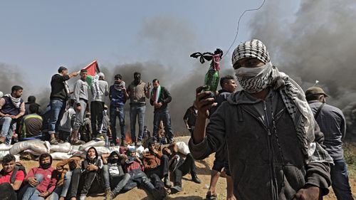 Palestinians protesters near the border with Israel. (AAP)