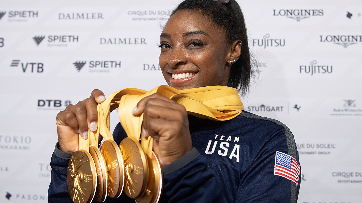 Simone Biles of the United States shows her five gold medals at the Gymnastics World Championships in Stuttgart